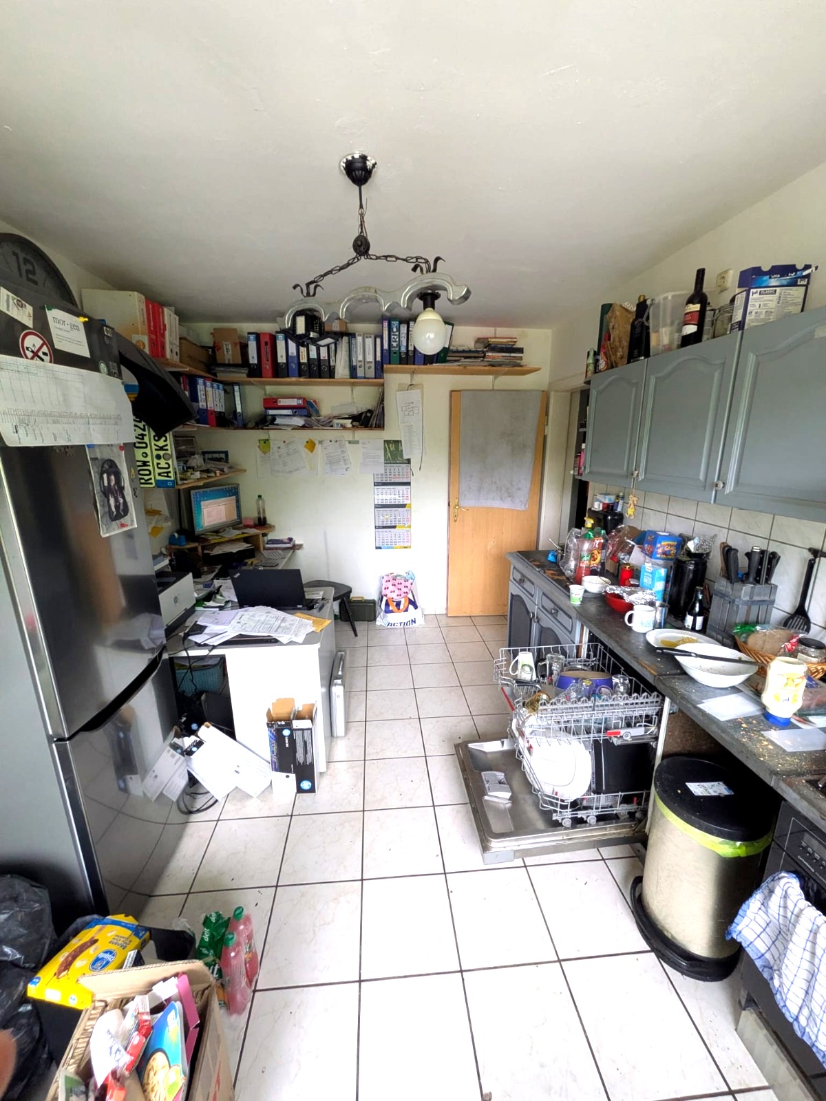 Before: cluttered apartment kitchen